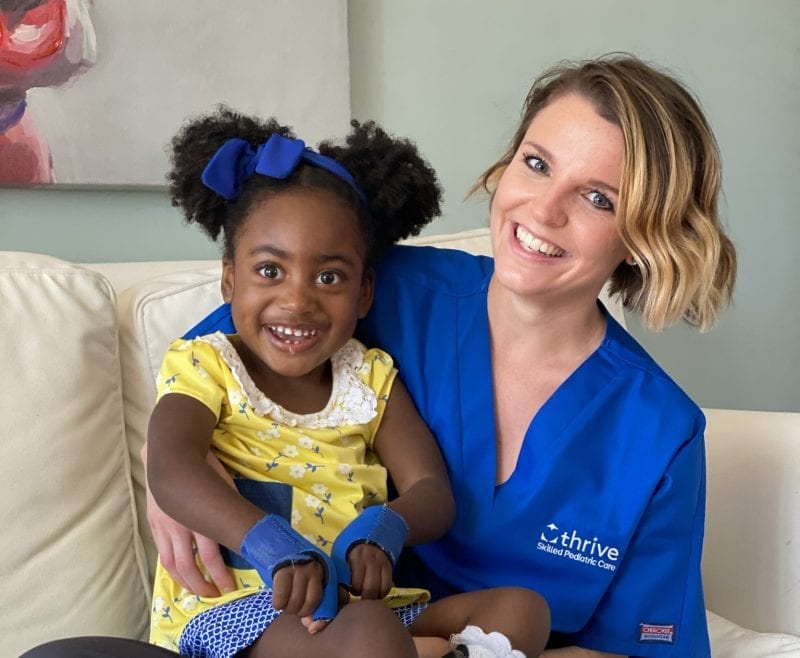 smiling little girl with thrive staff