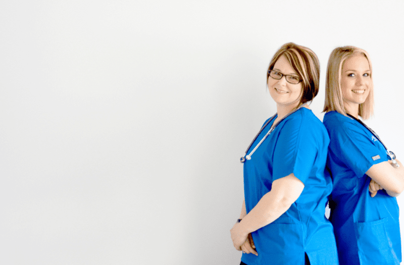 two Thrive SPC Nurses standing back to back