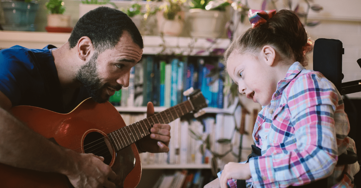 nurse playing guitar for patient