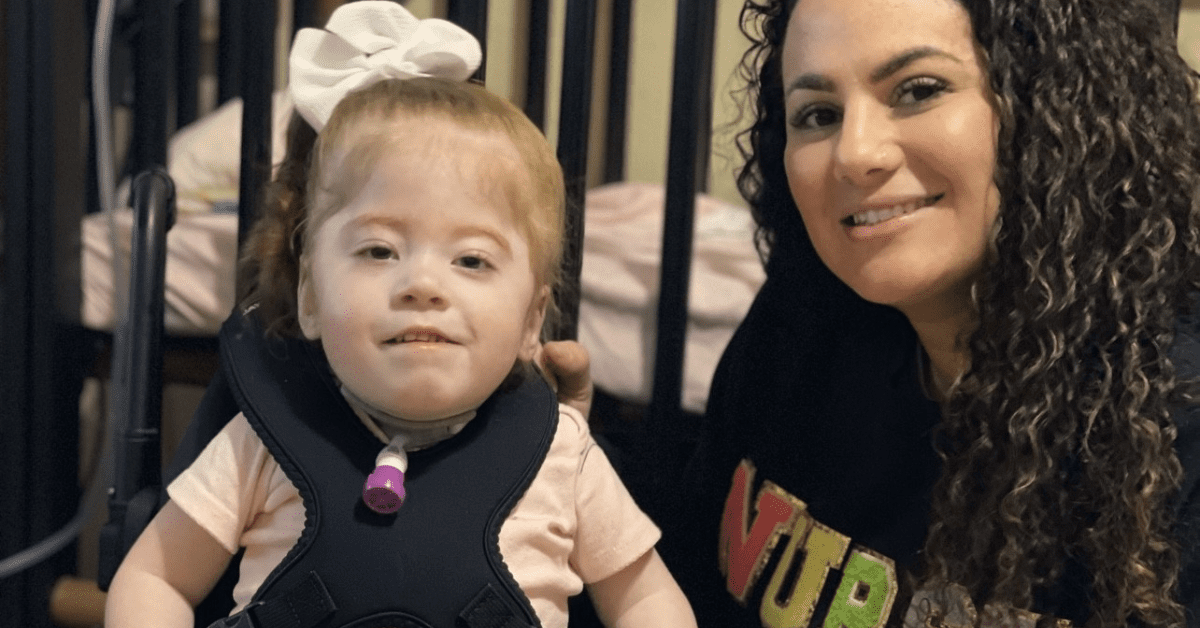 nurse with a child who has a feeding tube