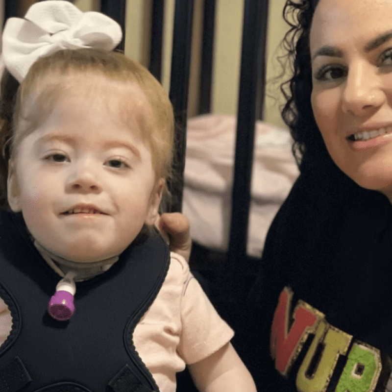 nurse with a child who has a feeding tube