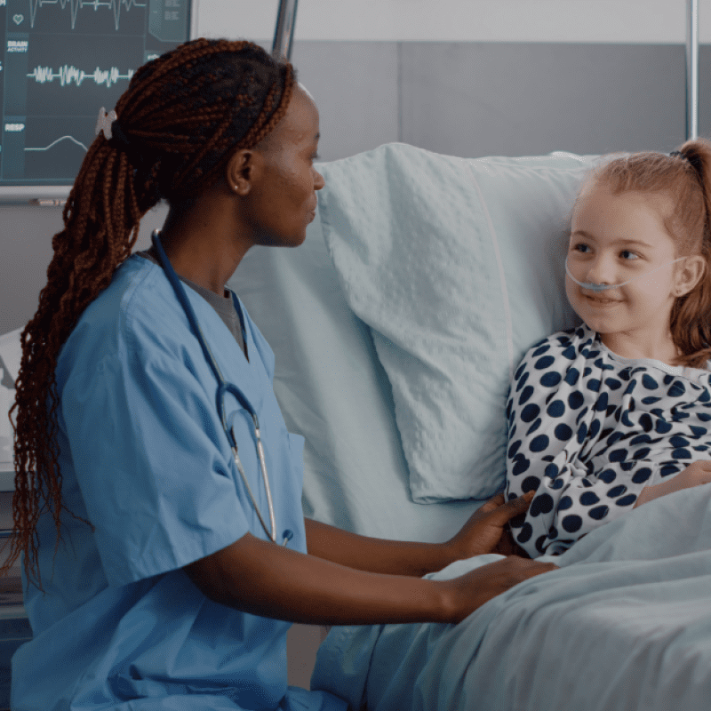nurse helping child in hospital bed, "How to Support Patients Post-Surgery